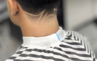 Textured haircut with a tapered neckline and line detail