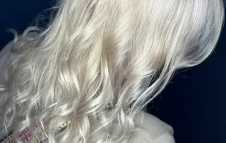 Long blonde hair styled in soft waves
